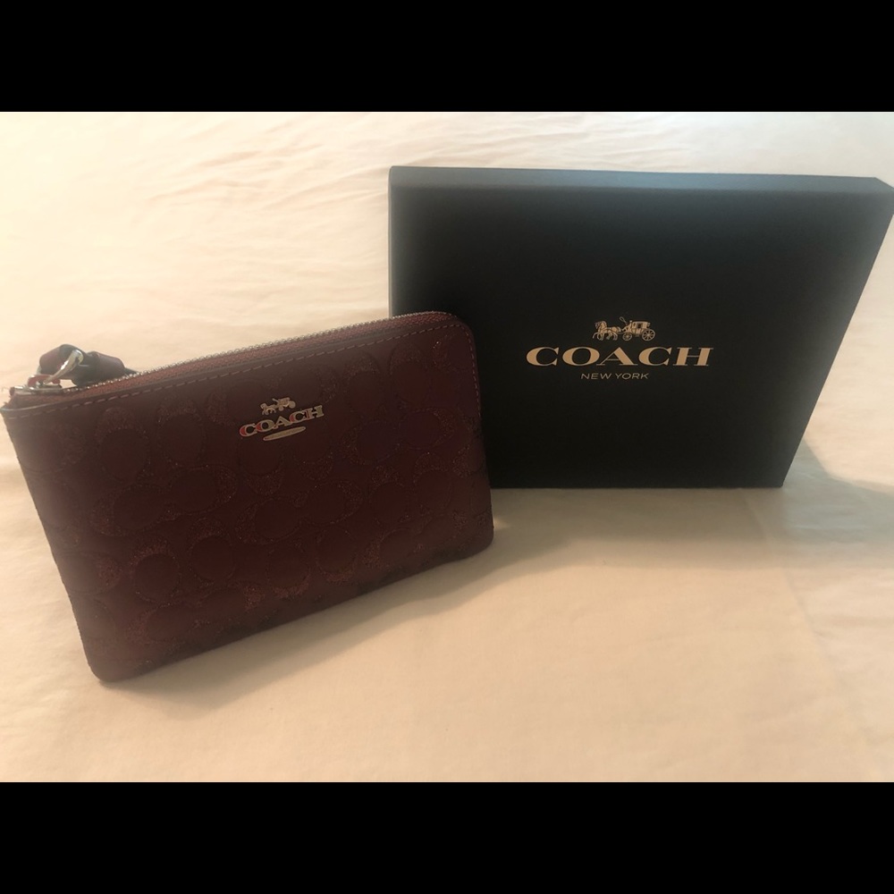 Coach wine color glitter and leather wristlet.